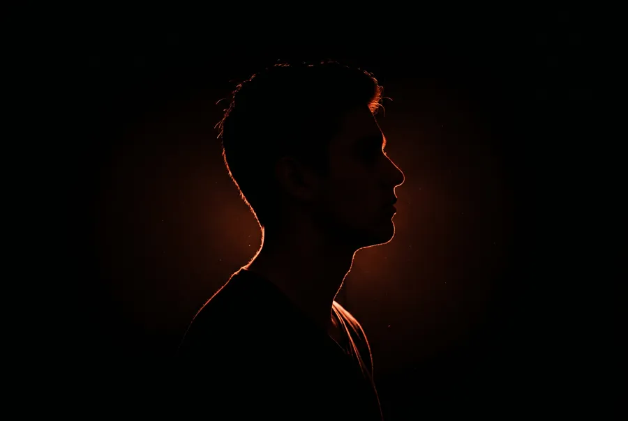 Cinematic presenter profile in ember rim light
